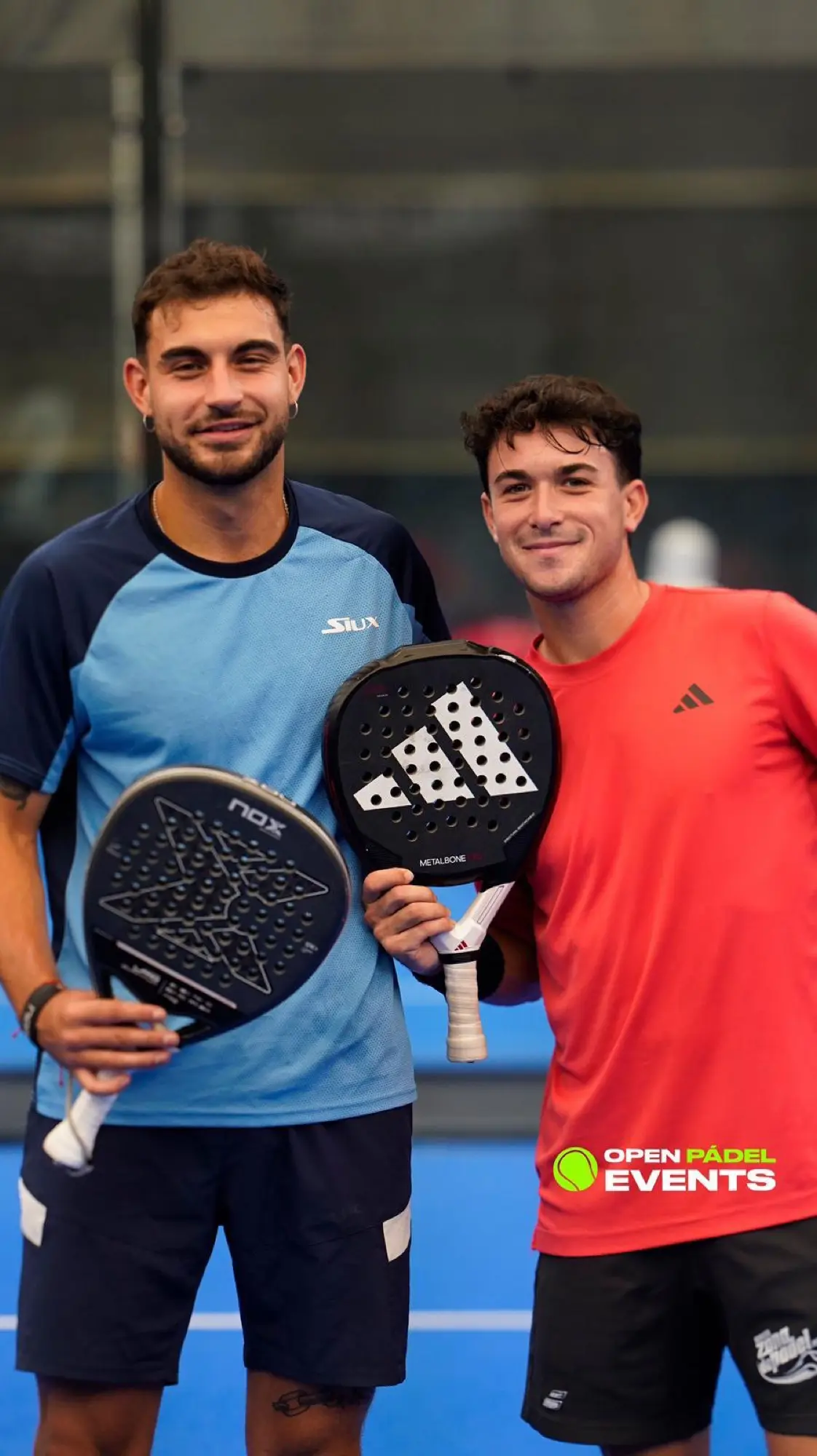 Two padel players holding rackets on court in Valencia