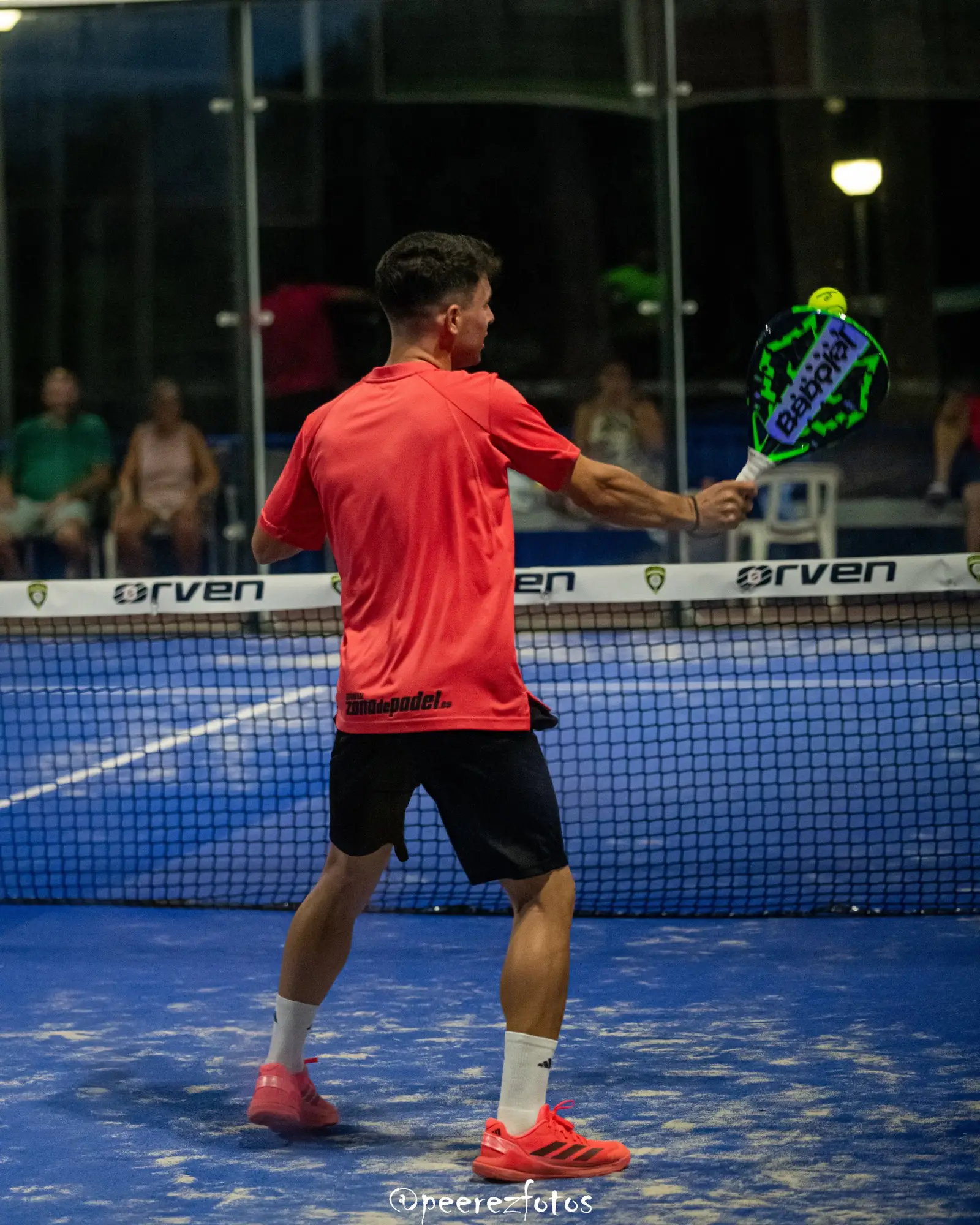 Backhand volley close to the glass wall