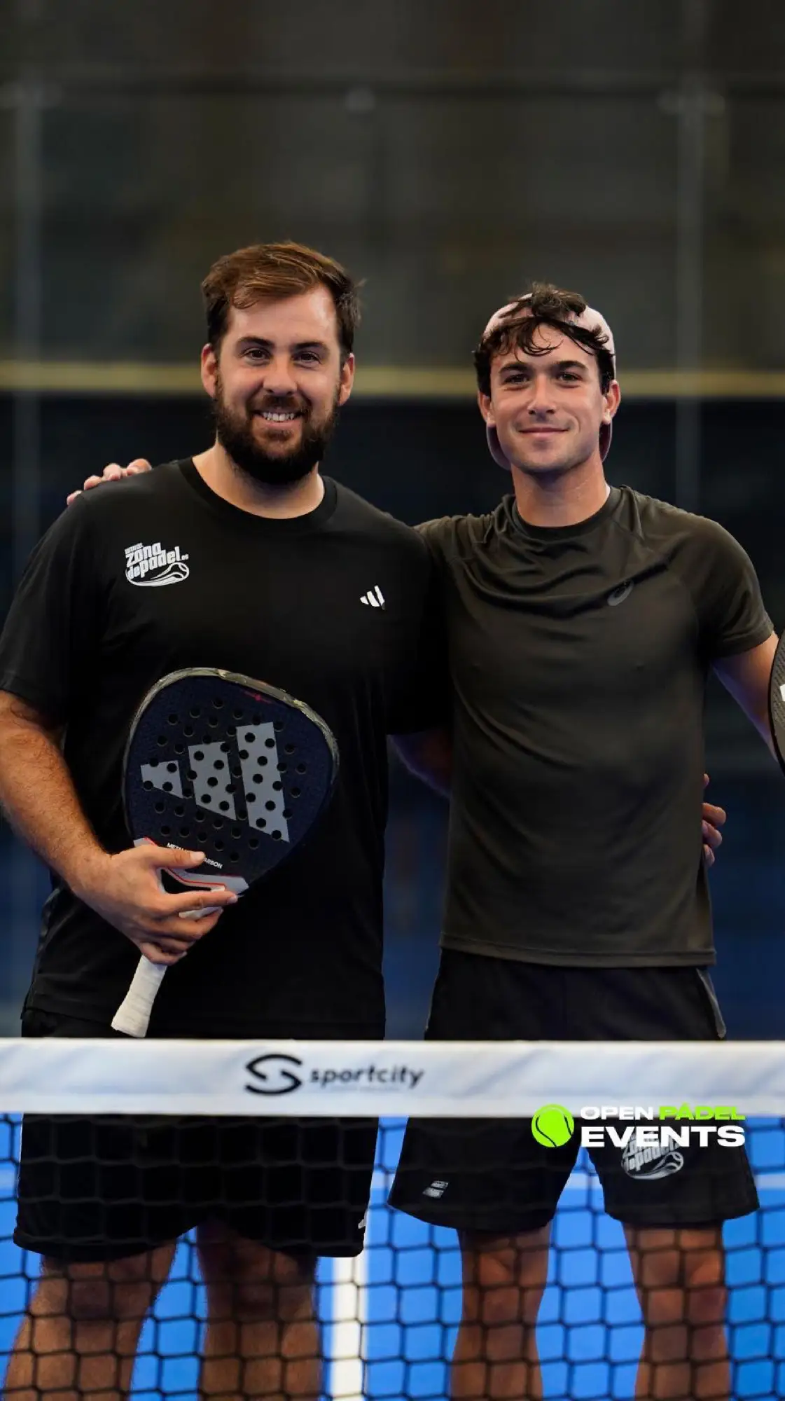 Two padel players with rackets after a session